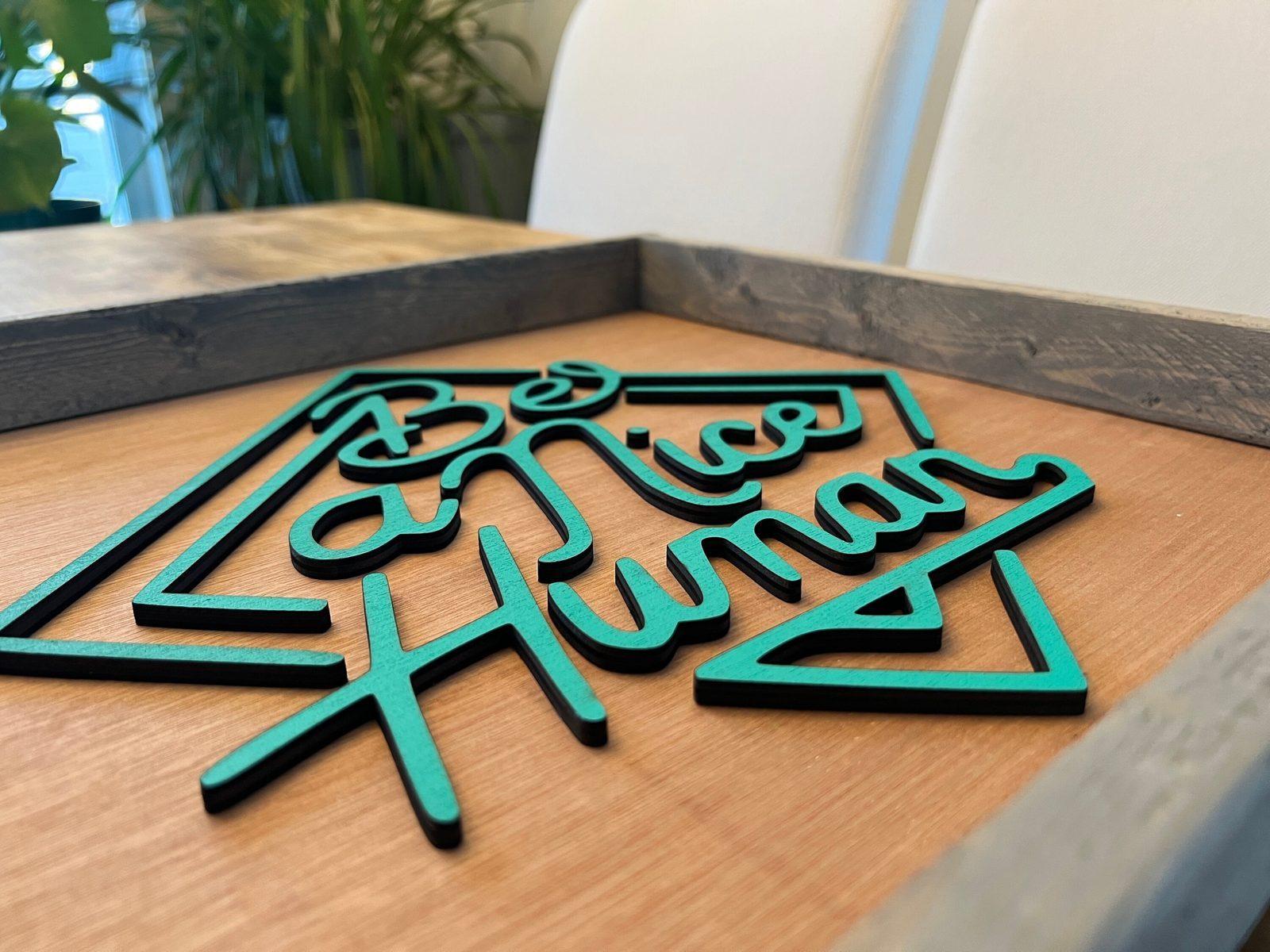 Be A Nice Human sign detail — raised lettering